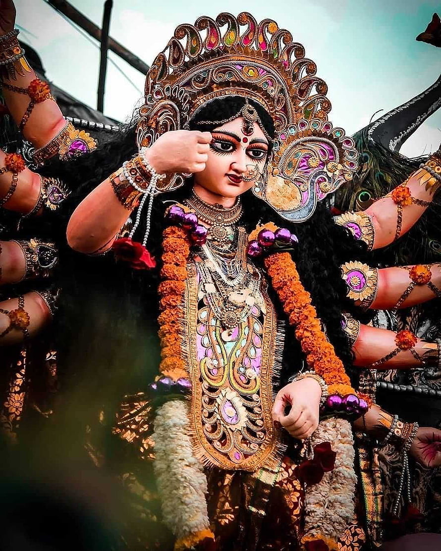 Maa Durga ornate idol with marigold garlands and traditional jewelry HD phone wallpaper