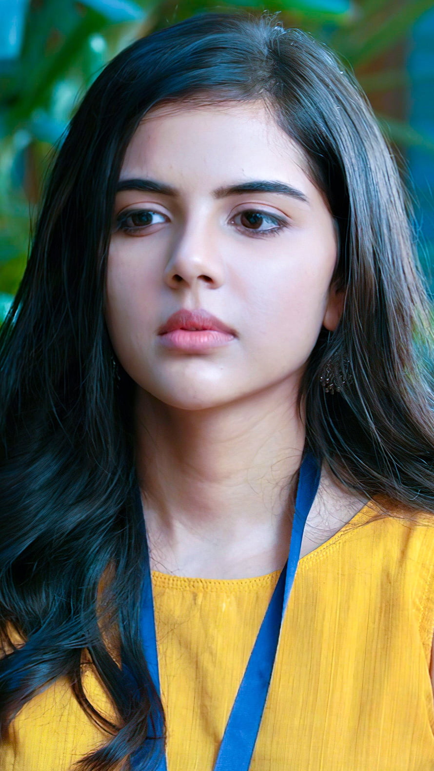 Kalyani Priyadarshini Portrait in Yellow Top with Blue Strap Against Green Foliage HD phone wallpaper