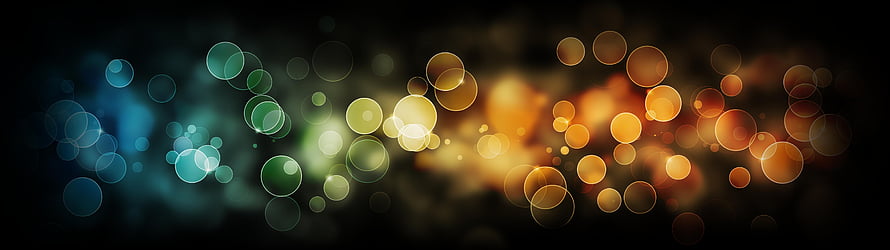 Abstract Bokeh Light Orbs Background With Blue Green And Orange Glowing Circles On Dark Canvas HD wallpaper