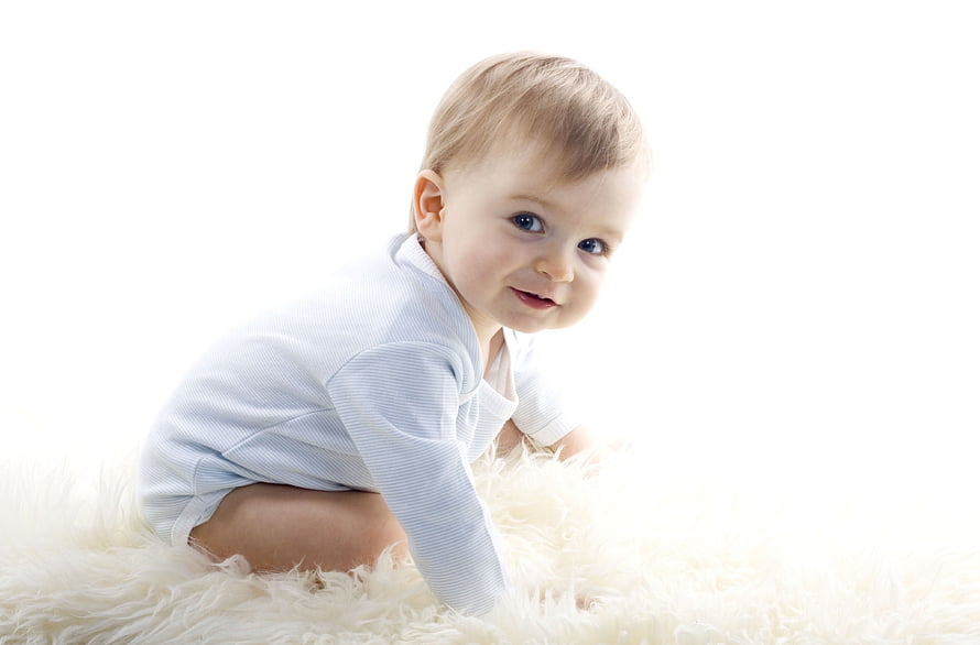 Smiling Baby Boy Crawling on White Fluffy Rug in Light Blue Onesie HD wallpaper