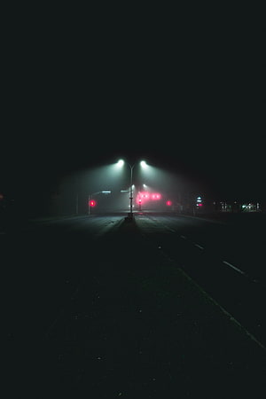 Empty City Road at Night with Glowing Streetlights and Red Traffic Signals in Fog HD phone wallpaper