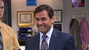 Michael Scott in a navy suit and patterned tie standing in an office with framed certificates on the wall HD wallpaper
