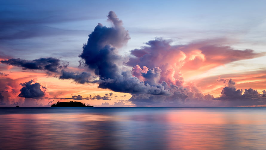 Dramatic Sunset Over Calm Ocean With Silhouette Island And Colorful Clouds HD wallpaper