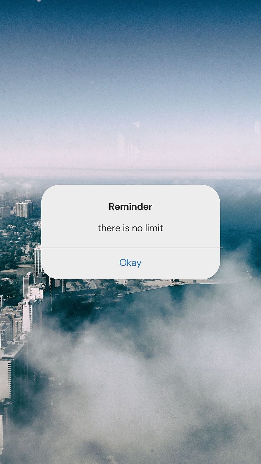 Aerial cityscape above the clouds with an inspirational reminder popup HD phone wallpaper