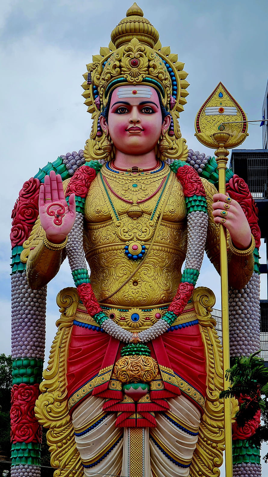 Vibrant Statue of Hindu Deity Murugan Holding Vel Spear with Abhaya Mudra HD phone wallpaper