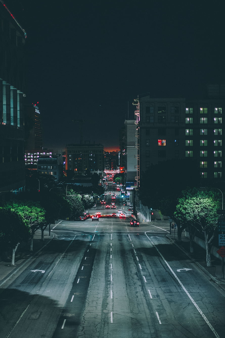 Cinematic Night Cityscape with Wet Streets and Distant Traffic Lights HD phone wallpaper