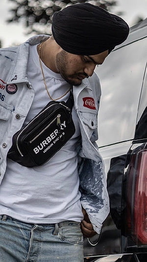 Sidhu Moose Wala in Black Turban and Distressed Denim Jacket with Burberry Sling Bag HD phone wallpaper