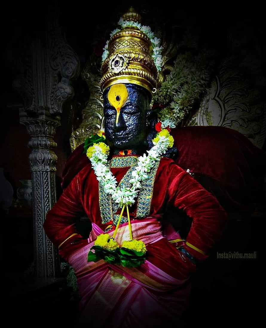 Statue of Lord Shiva adorned with a golden crown and flower garlands in a temple HD phone wallpaper