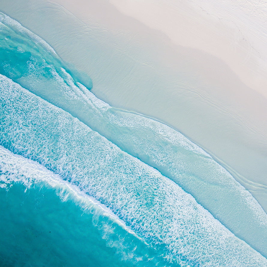 Aerial View of Turquoise Ocean Waves Rolling onto White Sand Beach HD phone wallpaper