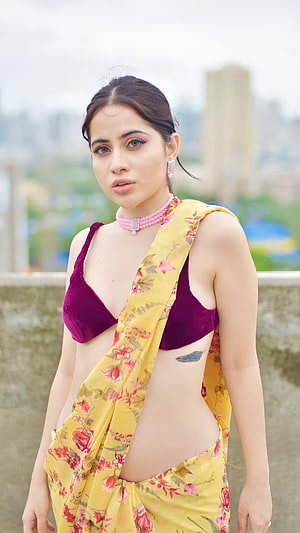 Urfi Javed in a yellow floral saree with a maroon velvet crop top and pink choker necklace HD phone wallpaper