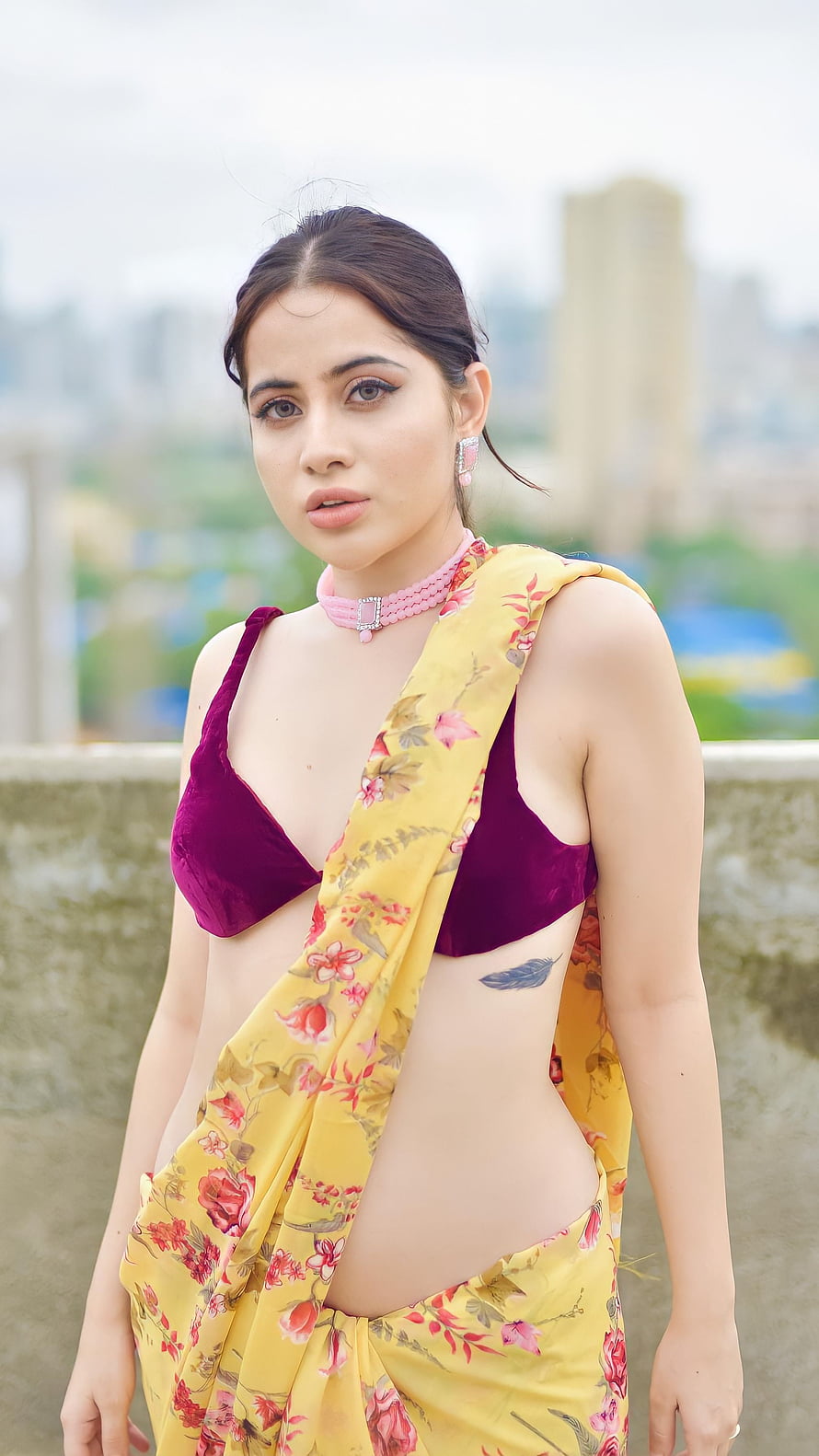 Urfi Javed in a yellow floral saree with a maroon velvet crop top and pink choker necklace HD phone wallpaper