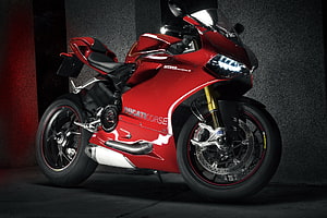 Red Ducati 1199 Panigale Superbike in Dark Studio Setting HD wallpaper