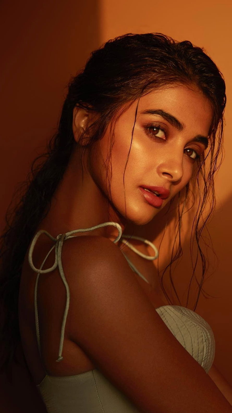 Pooja Hegde Portrait in Warm Amber Light with Wet Hair and White Top HD phone wallpaper