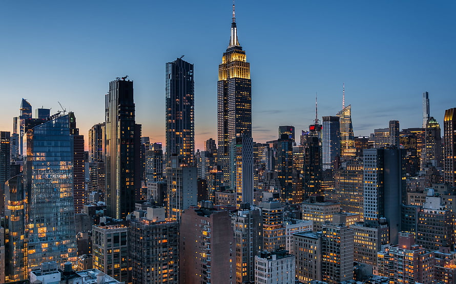 Empire State Building and Manhattan Skyline at Dusk with Warm City Lights HD wallpaper