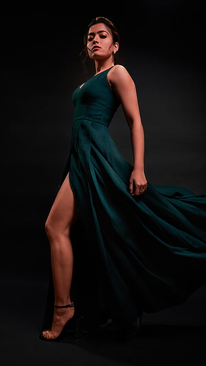 Adah Sharma in an elegant emerald green gown with a high slit posing against a dark background HD phone wallpaper