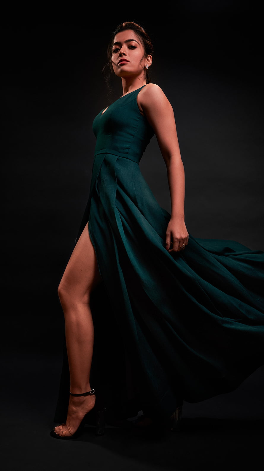 Adah Sharma in an elegant emerald green gown with a high slit posing against a dark background HD phone wallpaper