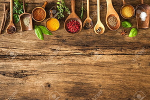 Assorted Spices and Herbs in Wooden Spoons on Rustic Table HD wallpaper