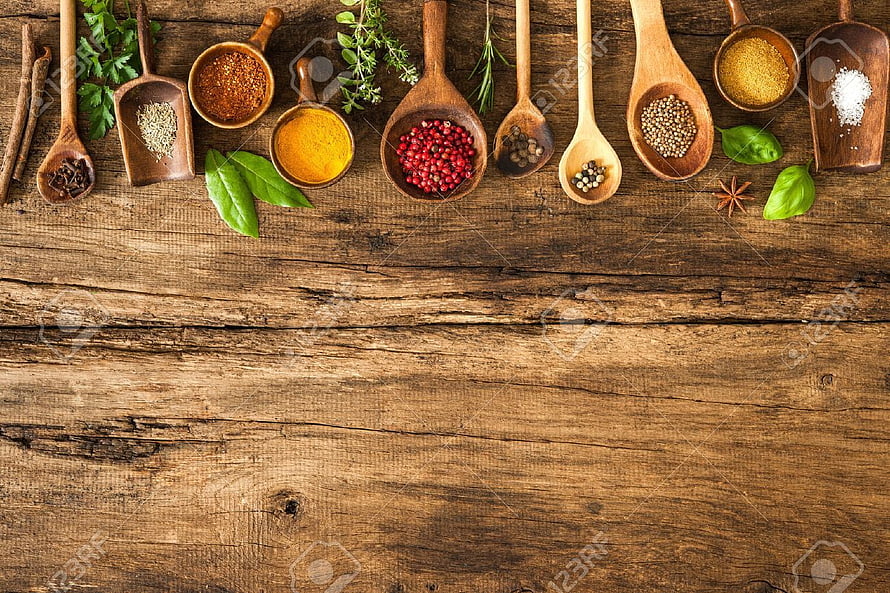 Assorted Spices and Herbs in Wooden Spoons on Rustic Table HD wallpaper