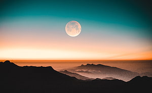 Full Moon Rising Over Silhouetted Mountain Ranges at Sunset HD wallpaper