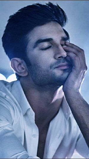 Sushant Singh Rajput in a moody blue-toned portrait wearing an open white shirt with eyes closed HD phone wallpaper