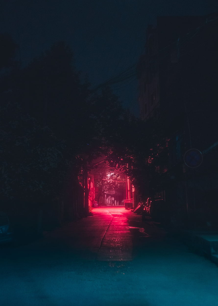 Moody Urban Alleyway at Night with Neon Red Glow and Wet Pavement HD phone wallpaper