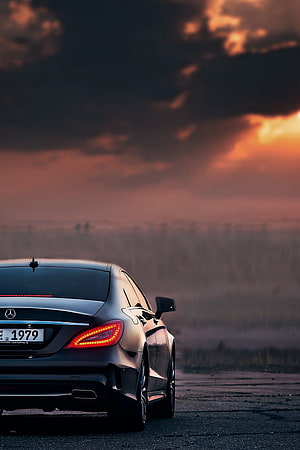 Mercedes-Benz CLS Coupe Rear View Against Dramatic Sunset Sky HD phone wallpaper