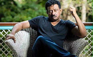 Ram Gopal Varma Portrait Sitting in Wicker Chair with Raised Fist HD wallpaper