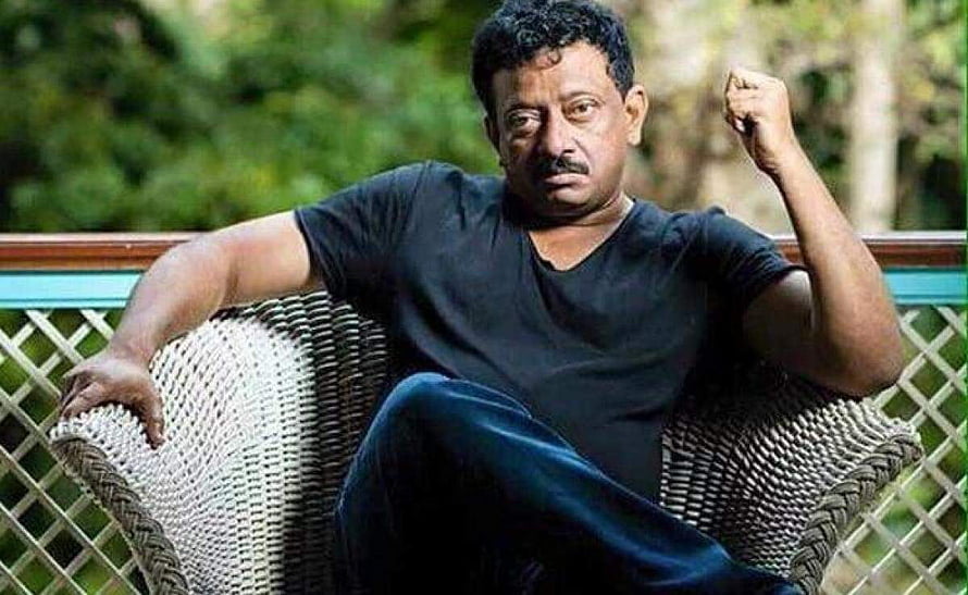 Ram Gopal Varma Portrait Sitting in Wicker Chair with Raised Fist HD wallpaper