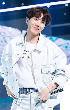 J-Hope from BTS in a white denim jacket on stage with a microphone HD phone wallpaper