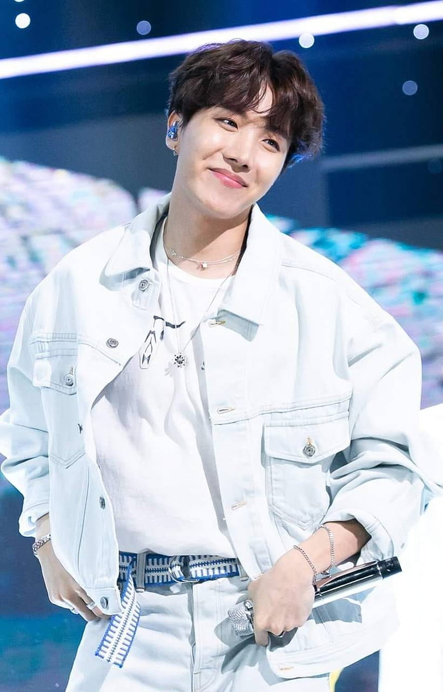 J-Hope from BTS in a white denim jacket on stage with a microphone HD phone wallpaper