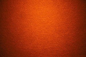 Warm Orange Carpet Texture with Soft Lighting and Subtle Grain HD wallpaper