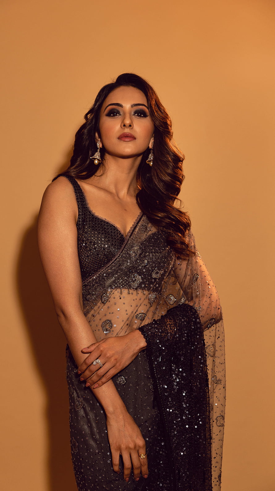 Rakul Preet Singh in an elegant black sequined saree with intricate beadwork and traditional jewelry HD phone wallpaper