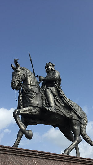 Bronze Equestrian Statue of a Warrior on Horseback Against Blue Sky HD phone wallpaper