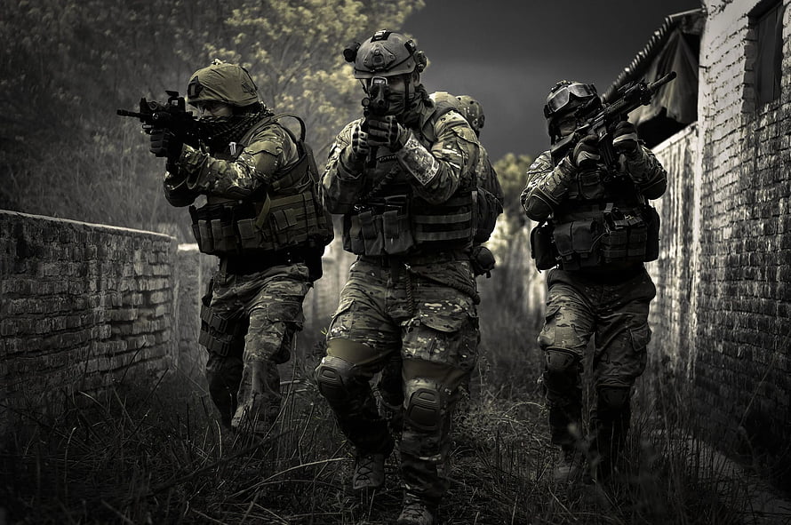 Three Tactical Operators in Full Combat Gear Moving Through a Narrow Alleyway HD wallpaper