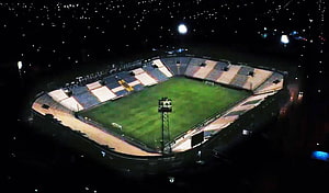 Aerial Night View of Alianza Lima Stadium with Illuminated Pitch and Surrounding City Lights HD wallpaper