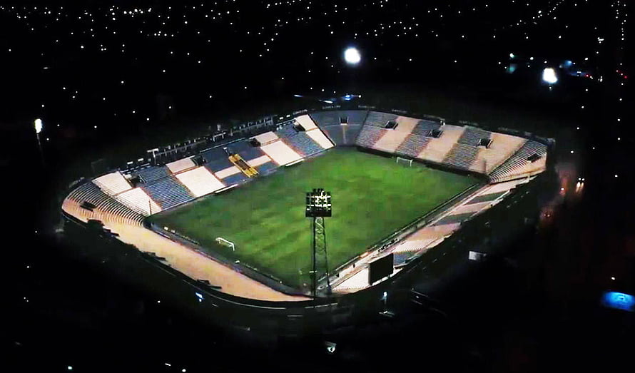 Aerial Night View of Alianza Lima Stadium with Illuminated Pitch and Surrounding City Lights HD wallpaper