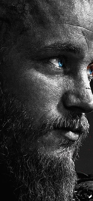 Ragnar Lothbrok Close-Up Portrait with Intense Blue Eyes and Weathered Beard HD phone wallpaper