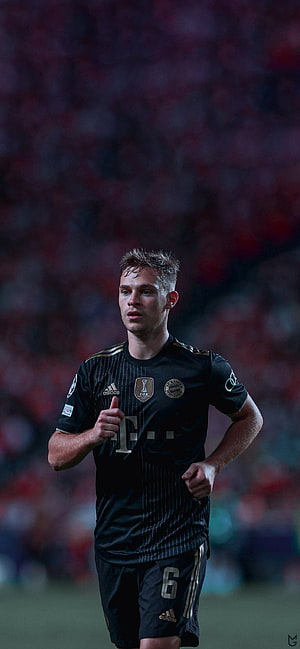Joshua Kimmich in Bayern Munich Black Away Kit on the Football Pitch HD phone wallpaper