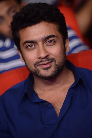 Suriya Portrait in Navy Blue Shirt with Warm Smile and Short Dark Hair HD phone wallpaper