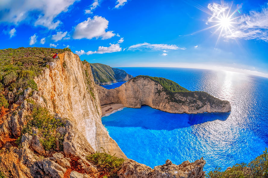 Navagio Beach in Zakynthos Greece with dramatic limestone cliffs and turquoise waters HD wallpaper