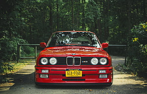 Classic Red BMW M3 E30 Front View Parked on a Forest Road HD wallpaper