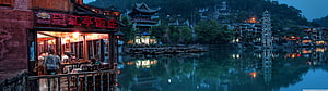 Fenghuang Ancient Town Riverside at Dusk with Traditional Architecture and Lanterns HD wallpaper