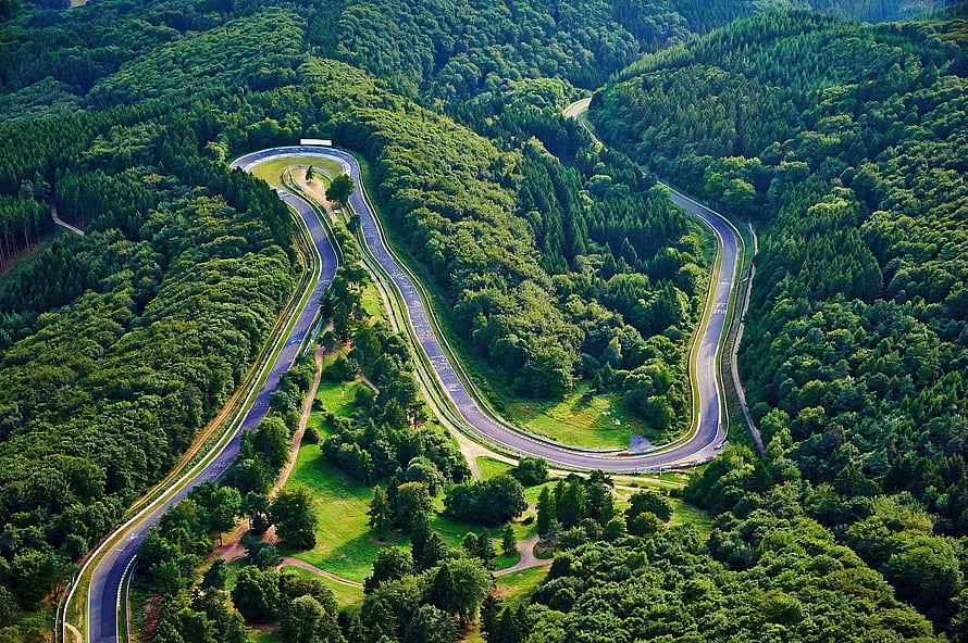 Aerial View of the Nordschleife at Nurburgring Winding Through Dense Forest HD wallpaper