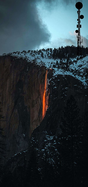 Firefall at Yosemite National Park with Snow-Capped Cliffs and Communication Tower HD phone wallpaper