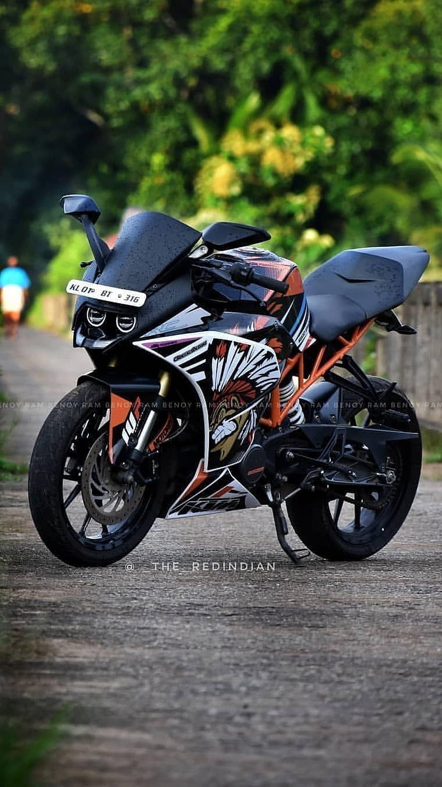 KTM RC 390 Sport Bike with Custom Graphic Wrap on a Scenic Road HD phone wallpaper