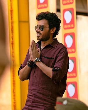 Dhanush in maroon shirt and sunglasses with hands folded in greeting pose HD phone wallpaper