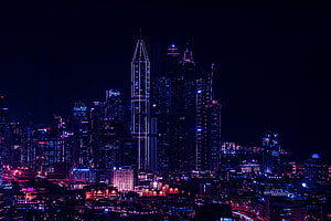 Macau skyline at night with illuminated skyscrapers and neon city lights HD wallpaper