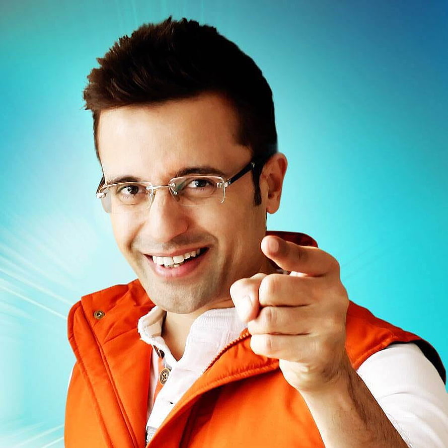Sandeep Maheshwari Portrait in Orange Vest Pointing at Camera HD phone wallpaper