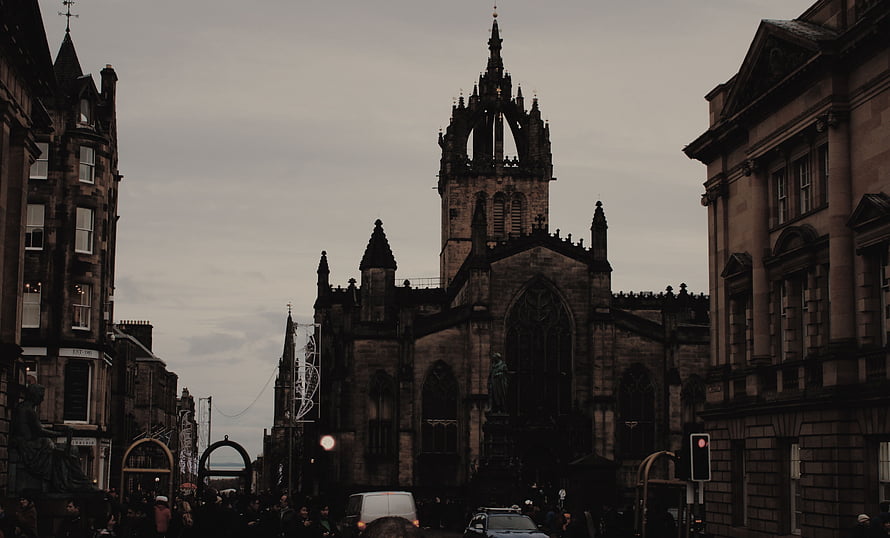 Gothic Cathedral Tower Rising Over Historic European Street at Dusk HD wallpaper