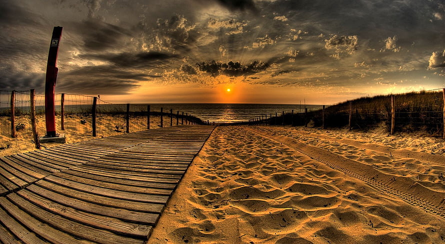 Dramatic Golden Hour Beach Sunset with Wooden Boardwalk and Sand Dunes HD wallpaper